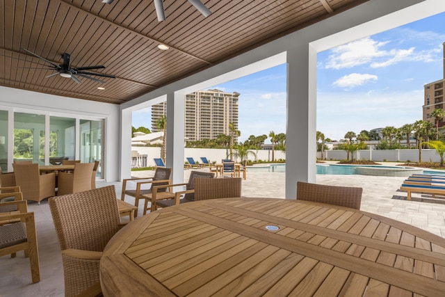 exterior space featuring a fenced in pool and ceiling fan