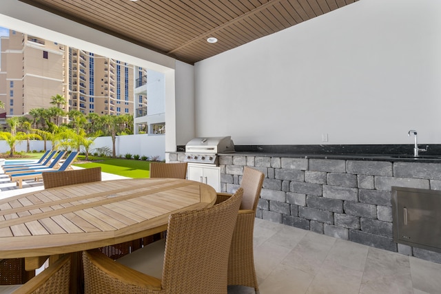 view of patio featuring grilling area, sink, and an outdoor kitchen