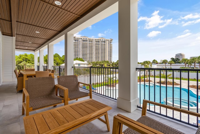 balcony with a fenced in pool