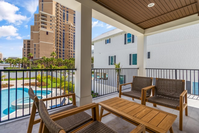 balcony featuring a fenced in pool