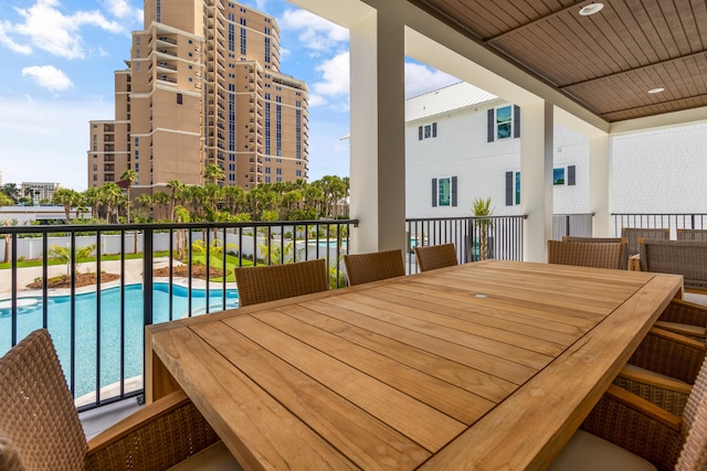 balcony featuring a fenced in pool