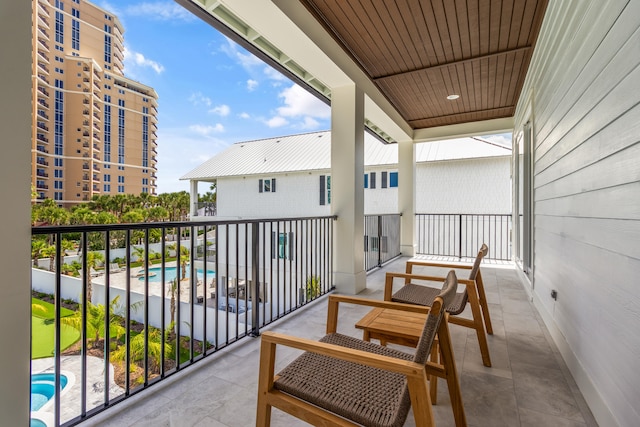 balcony featuring a community pool