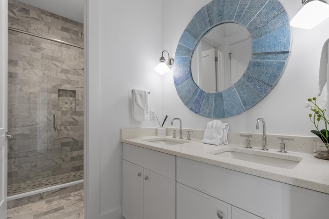 bathroom featuring walk in shower and dual bowl vanity