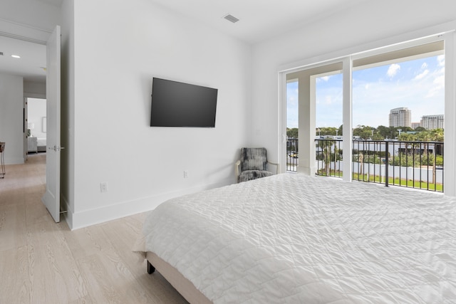 bedroom with light hardwood / wood-style floors and access to exterior