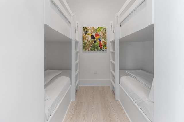 spacious closet with light hardwood / wood-style flooring