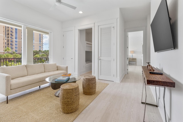 living room with light hardwood / wood-style floors and ceiling fan