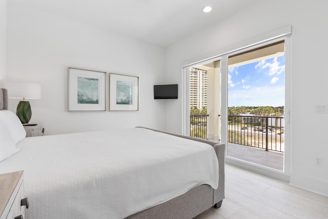 bedroom with light hardwood / wood-style flooring and access to outside