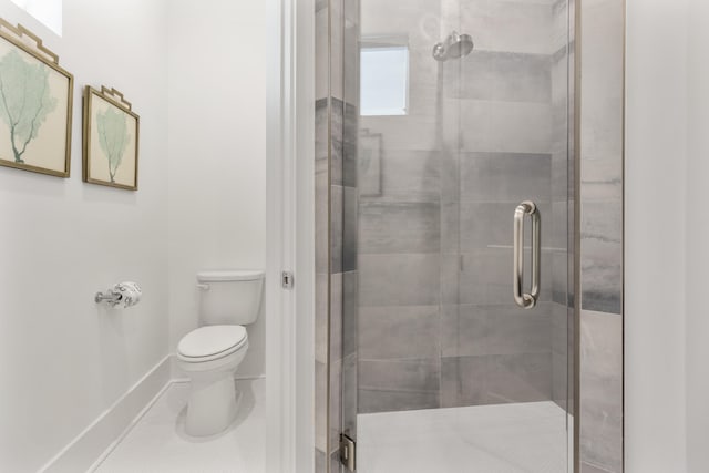 bathroom with a shower with door and toilet