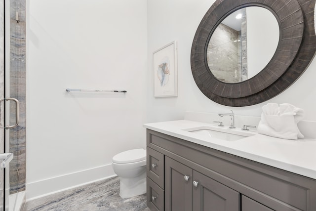 bathroom with large vanity, an enclosed shower, and toilet