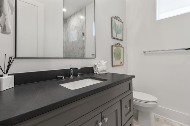 bathroom featuring vanity with extensive cabinet space and toilet