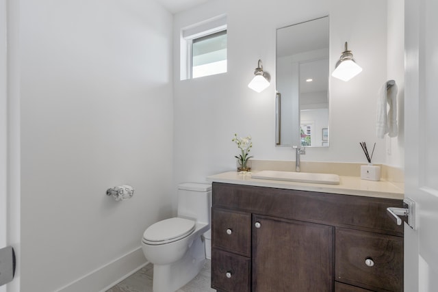 bathroom featuring toilet and vanity