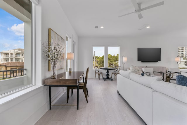 living room featuring ceiling fan and light wood-type flooring