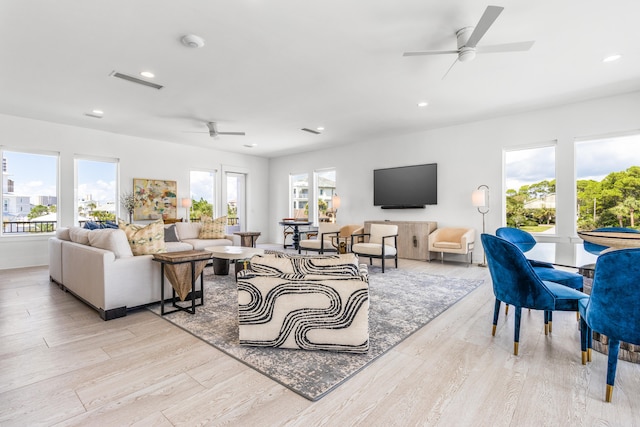 living room featuring light hardwood / wood-style floors and ceiling fan