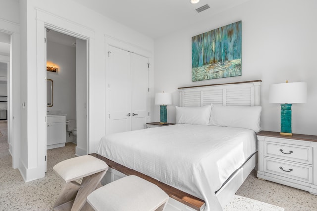 bedroom with a closet and ensuite bathroom