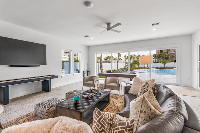 living room with ceiling fan and a wealth of natural light