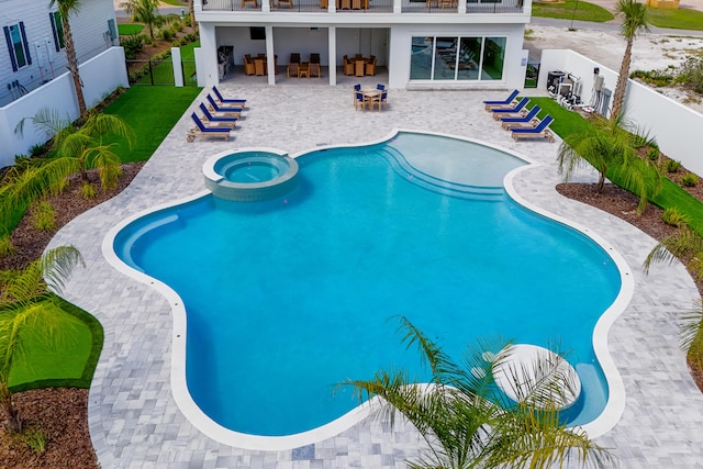 view of pool featuring an in ground hot tub and a patio area