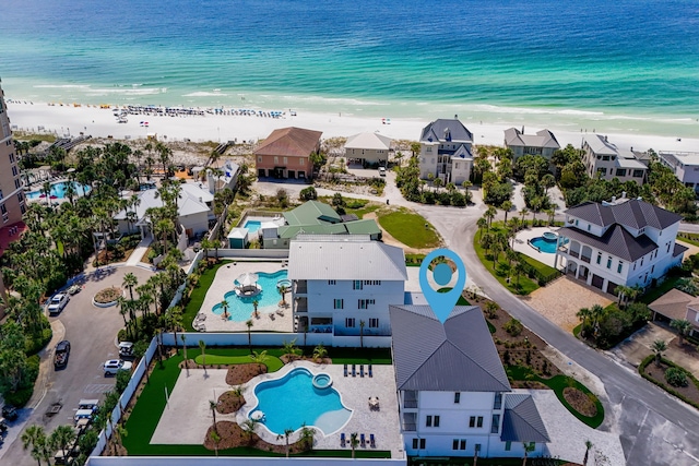 bird's eye view featuring a view of the beach and a water view