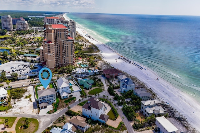 bird's eye view featuring a water view and a beach view