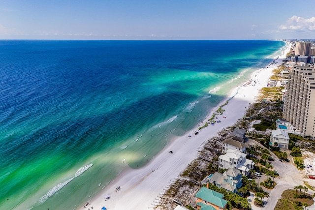 birds eye view of property featuring a beach view and a water view