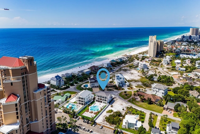 drone / aerial view with a water view and a beach view