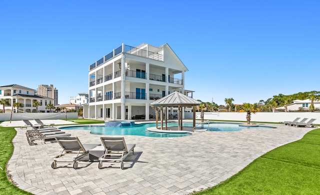 view of pool featuring pool water feature and a patio area