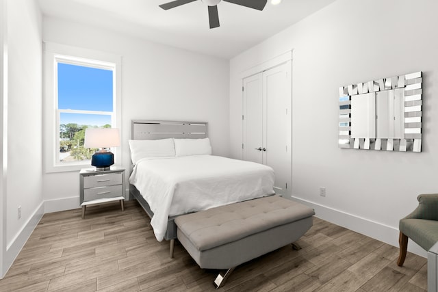 bedroom featuring a closet, ceiling fan, and light wood-type flooring