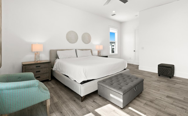 bedroom with light hardwood / wood-style flooring and ceiling fan