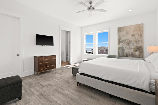 bedroom with light hardwood / wood-style floors and ceiling fan