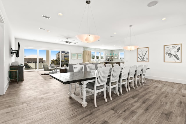 dining area with ceiling fan and light wood-type flooring