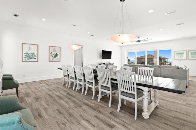 dining area featuring light hardwood / wood-style flooring and ceiling fan