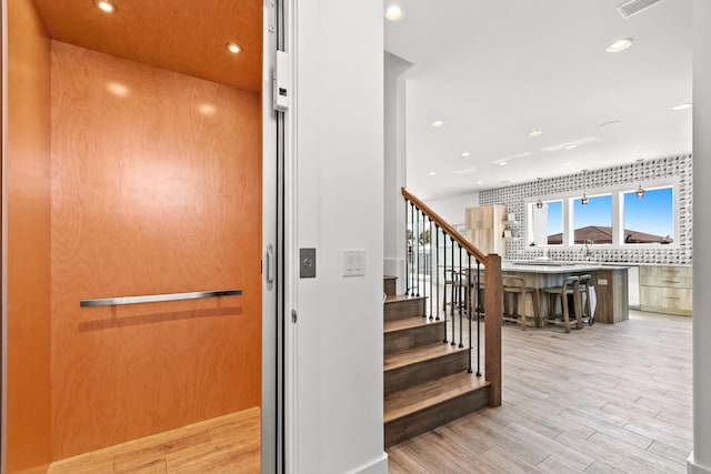 interior space featuring light hardwood / wood-style flooring and elevator