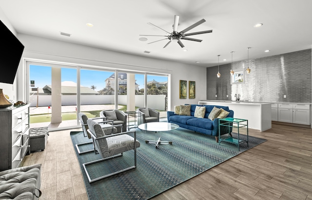 living room featuring ceiling fan and light wood-type flooring