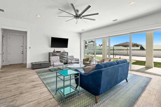 living room with ceiling fan and light wood-type flooring