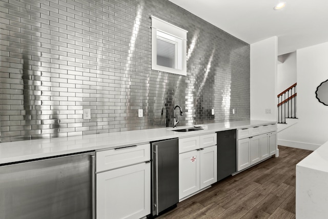 bar featuring white cabinets, dishwashing machine, dark hardwood / wood-style flooring, sink, and tasteful backsplash