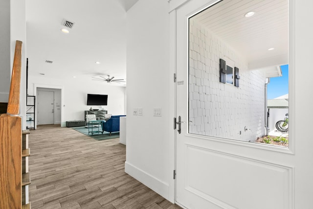 hallway with a wealth of natural light and light wood-type flooring