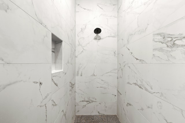 bathroom with a tile shower