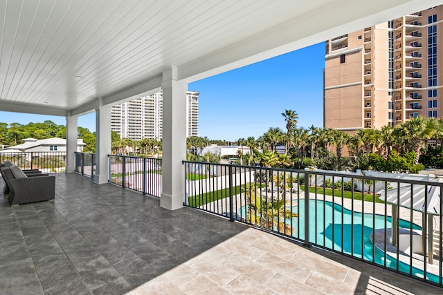 balcony with a fenced in pool