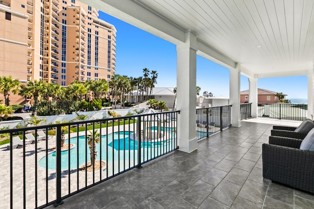 balcony featuring a community pool