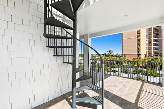 staircase featuring tile flooring