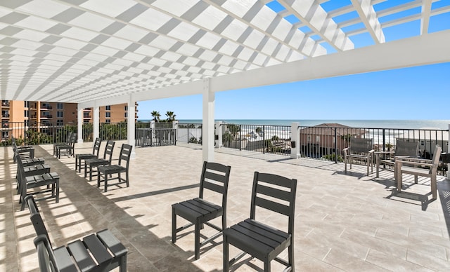 view of terrace featuring a pergola and a water view