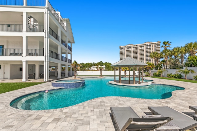 view of pool with a patio and an in ground hot tub