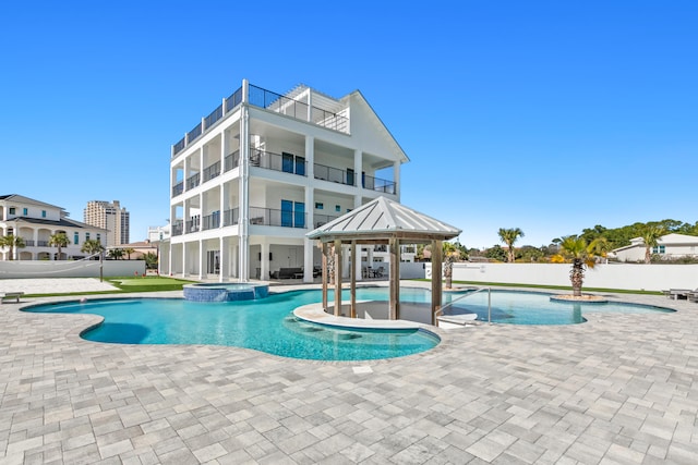 view of pool featuring an outdoor hot tub and a patio area