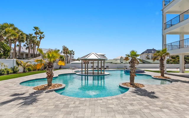 view of swimming pool featuring a patio, a gazebo, and an in ground hot tub