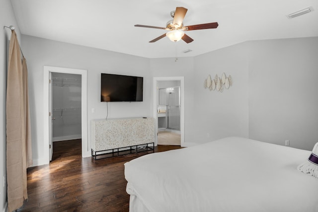 bedroom with a closet, ceiling fan, connected bathroom, a walk in closet, and dark hardwood / wood-style flooring