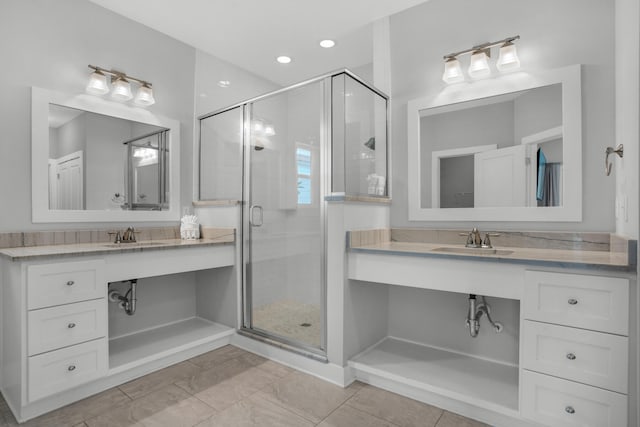 bathroom featuring vanity with extensive cabinet space, an enclosed shower, and tile flooring