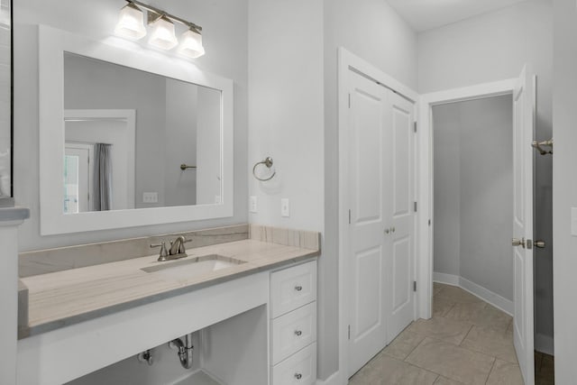 bathroom featuring tile flooring and vanity