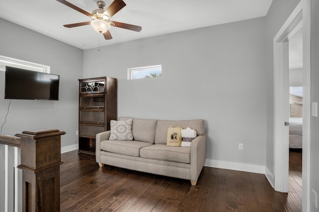 living room with ceiling fan and dark wood-type flooring