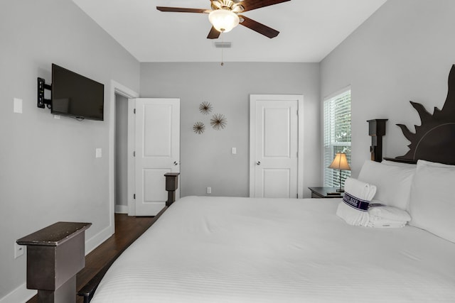 bedroom featuring ceiling fan and dark hardwood / wood-style floors