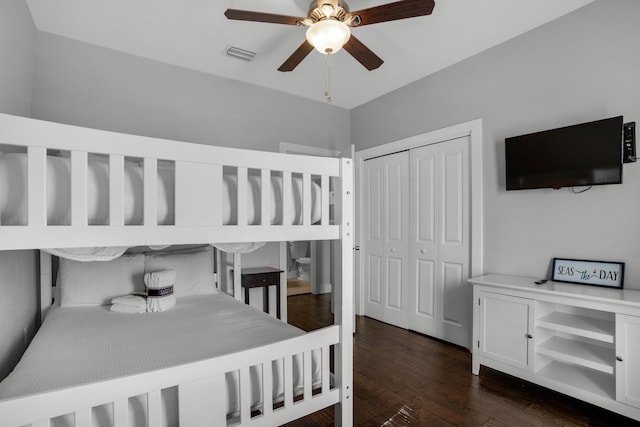 bedroom featuring a closet, dark wood-type flooring, and ceiling fan