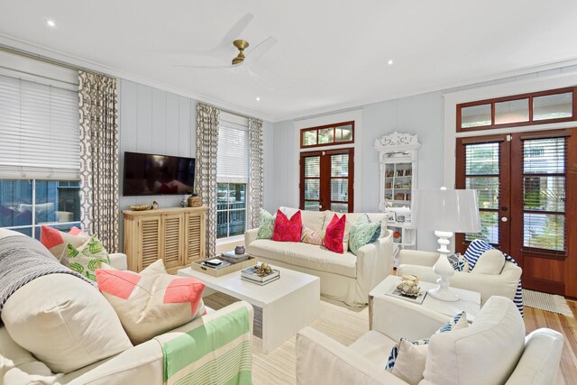 living room featuring light hardwood / wood-style flooring, french doors, ceiling fan, and ornamental molding